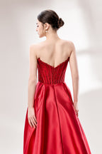 Against a light - hued background, a woman wears a red satin gown with a strapless, lace - detailed bodice and pockets. It has a voluminous skirt, combining romance and functionality. The vibrant red color and elegant design radiate confidence, perfect for formal events like weddings or award ceremonies.6