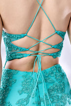 Set against a light background, a woman dons a turquoise tulle gown adorned with floral lace. It has thin straps, a sweetheart neckline, and a mermaid - shaped skirt with a high side slit. The delicate lace and flowing fabric exude romance, ideal for weddings or formal dinners.6