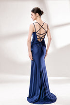 Set against a light background, a woman wears a navy - blue satin gown. It boasts thin straps, a draped neckline, and a mermaid silhouette with a high side slit. The smooth fabric and ruched design exude sophistication, ideal for formal events like proms.2