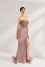 A woman with sleek dark hair and a confident stance wears a multi - colored, sequined strapless gown. It has a form - fitting silhouette, a high side slit, and bead - detailed bodice. Paired with silver heels, the outfit radiates glamour, perfect for formal events like galas or award ceremonies.3