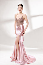 Set against a light backdrop, a woman dons a pink satin gown with a beaded, sheer bodice and a mermaid silhouette. The intricate bead patterns and flowing train add romance, combining sophistication and allure. Ideal for weddings or formal ceremonies, it exudes a regal aura.3