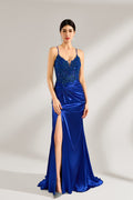 A woman stands against a light background, wearing a royal - blue satin gown. It features thin criss - cross straps at the back, intricate lace embroidery on the bodice, and a mermaid silhouette with a trailing skirt. The elegant design creates a glamorous look, perfect for formal events like galas or red - carpet occasions.1
