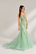 The model wearing it has long, wavy hair tied up in a half-up style, and she accessorizes with elegant earrings. The dress adopts a fresh light green color. The spaghetti strap design reveals the graceful shoulder and neck lines, and the deep V-neck adds a touch of sexiness. The mermaid skirt is paired with light tulle, embellished with exquisite embroidery and beading, making the whole dress look elegant and luxurious. It is very suitable for formal occasions such as dinners and weddings.1