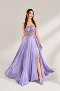 A woman with long, wavy dark hair and a confident pose wears a light - purple satin gown. It has thin straps, a sheer lace - detailed bodice, and a high side slit. Paired with silver - tone heels, the outfit radiates elegance, perfect for formal events like galas or evening receptions.1