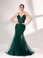 ：Illuminated softly, a woman captivates in a dark green evening gown. With sequin - tulle, mermaid silhouette, and sheer details, it creates a glamorous and sophisticated look for formal events.1