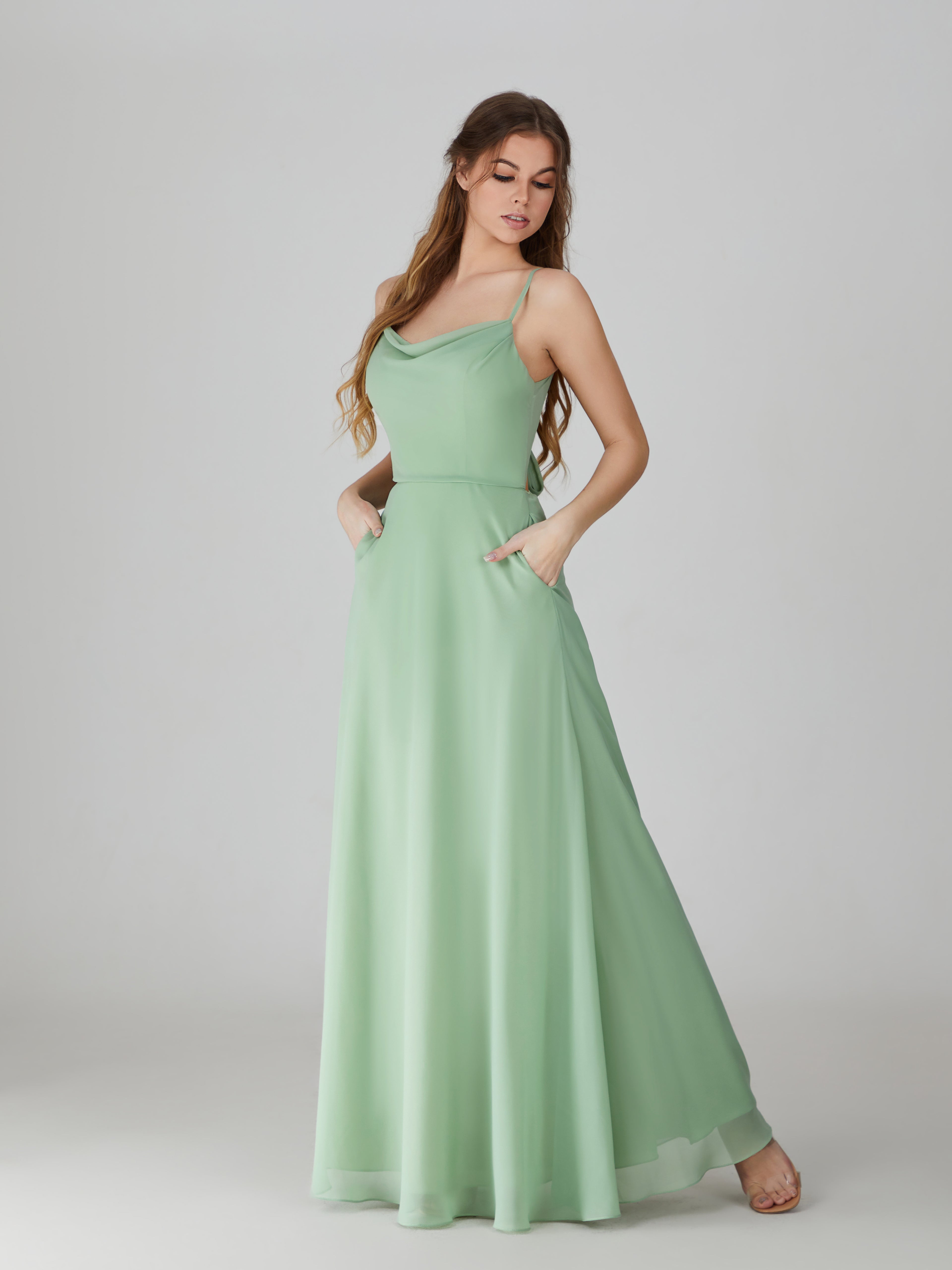 Sage green chiffon bridesmaid dress with cowl neckline, spaghetti straps, and pockets