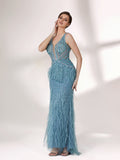 In soft lighting, a woman dazzles in a blue evening gown. With feather details, sequin embellishments, and a mermaid silhouette, it creates a luxurious and eye - catching look for formal events.1