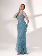 In soft lighting, a woman dazzles in a blue evening gown. With feather details, sequin embellishments, and a mermaid silhouette, it creates a luxurious and eye - catching look for formal events.1