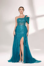 Against a light - hued backdrop, a woman dons a teal sequin gown with an one - shoulder design. It features a bow - detailed strap, a sheer waist panel, and a high side slit. The sparkling sequins and unique silhouette radiate glamour, perfect for formal dinners or galas.3