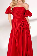 A woman with long, wavy blonde hair and a bright smile wears a vibrant red satin gown. It has thin spaghetti straps, a ruched bodice, and a voluminous, flowing skirt with a subtle train. Paired with simple, light - colored heels, the outfit exudes elegance, perfect for formal events like galas or weddings.03