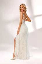 Illuminated by soft light, a woman captivates in a white feather - trimmed gown. It has thin straps, a V - neckline with intricate beadwork, and a high side slit. The glamorous design, with its feathery texture, creates an eye - catching and elegant look, perfect for formal events or red - carpet moments.3
