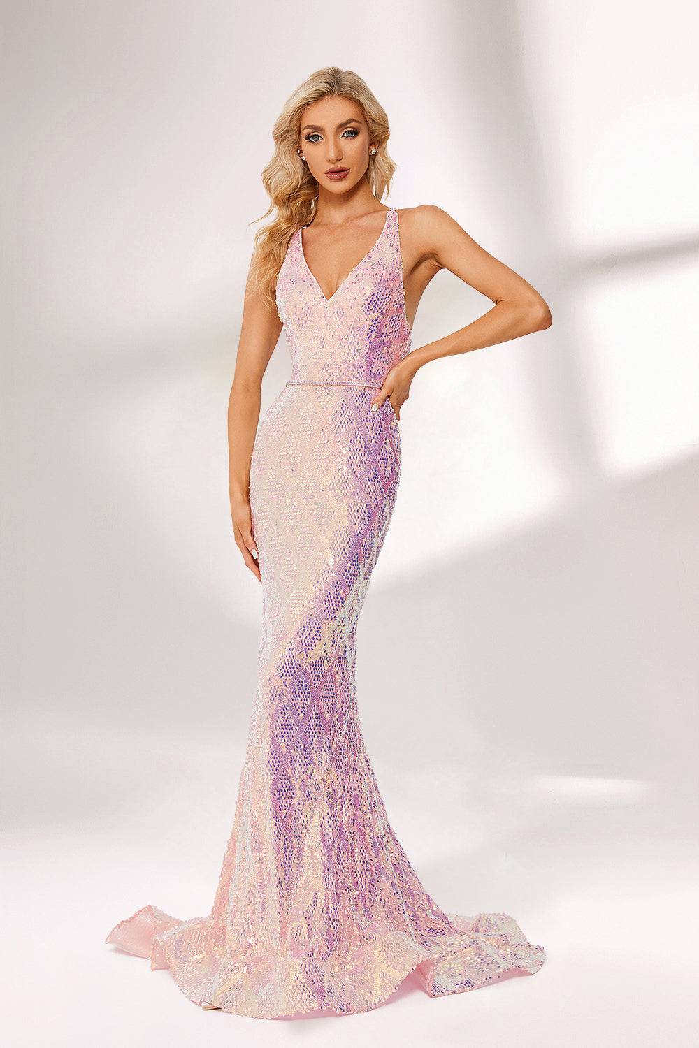 A woman stands against a light background, wearing a pink - purple ombre sequin gown. It features a deep V - neckline, a mermaid silhouette, and a low back. The shimmering sequins create a glamorous effect, perfect for formal events like galas or proms, exuding elegance and charm.1