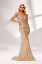 A woman stands against a light background, wearing a champagne - colored mermaid - style gown. It features a deep V - neckline, intricate beadwork throughout, and long sheer sleeves. The elegant design creates a glamorous and sophisticated look, perfect for formal events like galas or weddings.3