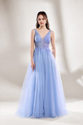 Bathed in soft light, a woman dazzles in a light blue tulle gown. It has a deep V - neckline with delicate lace embroidery on the bodice, and a flowing tulle skirt. The ethereal design creates a romantic and dreamy look, perfect for formal events like proms or weddings.1