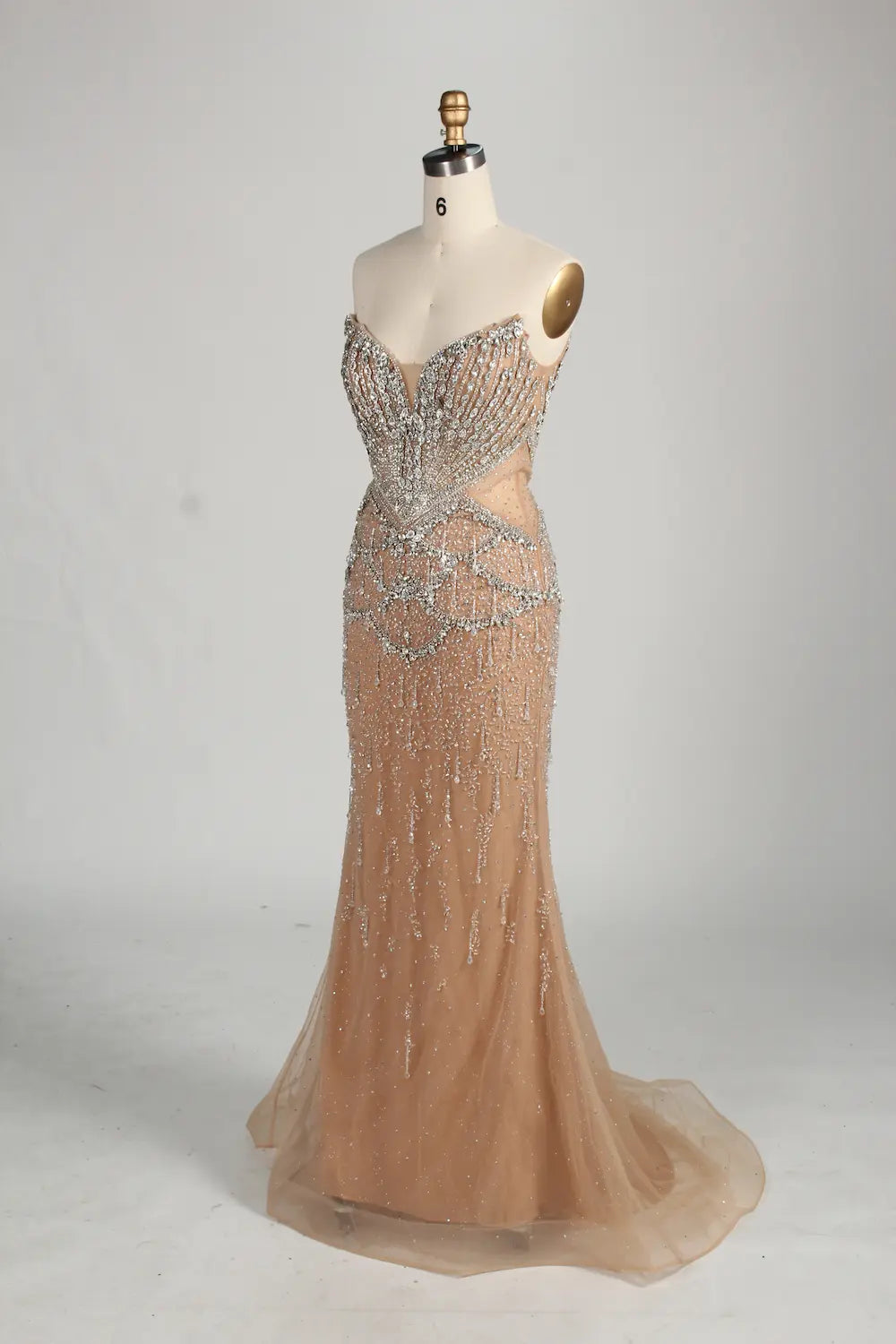 Champagne mermaid gown with beaded halter neckline and shoulder cape