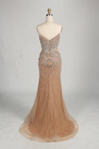 Beaded halter mermaid gown in champagne tulle with flowing hem