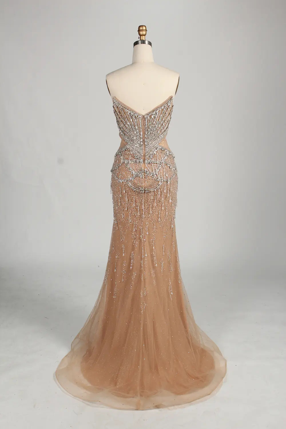 Beaded halter mermaid gown in champagne tulle with flowing hem
