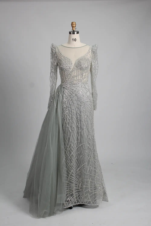 Silver long-sleeve mermaid gown with beaded lace texture and draped side overskirt