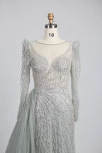Silver long-sleeve mermaid gown with sweetheart neckline and shimmering beaded lace
