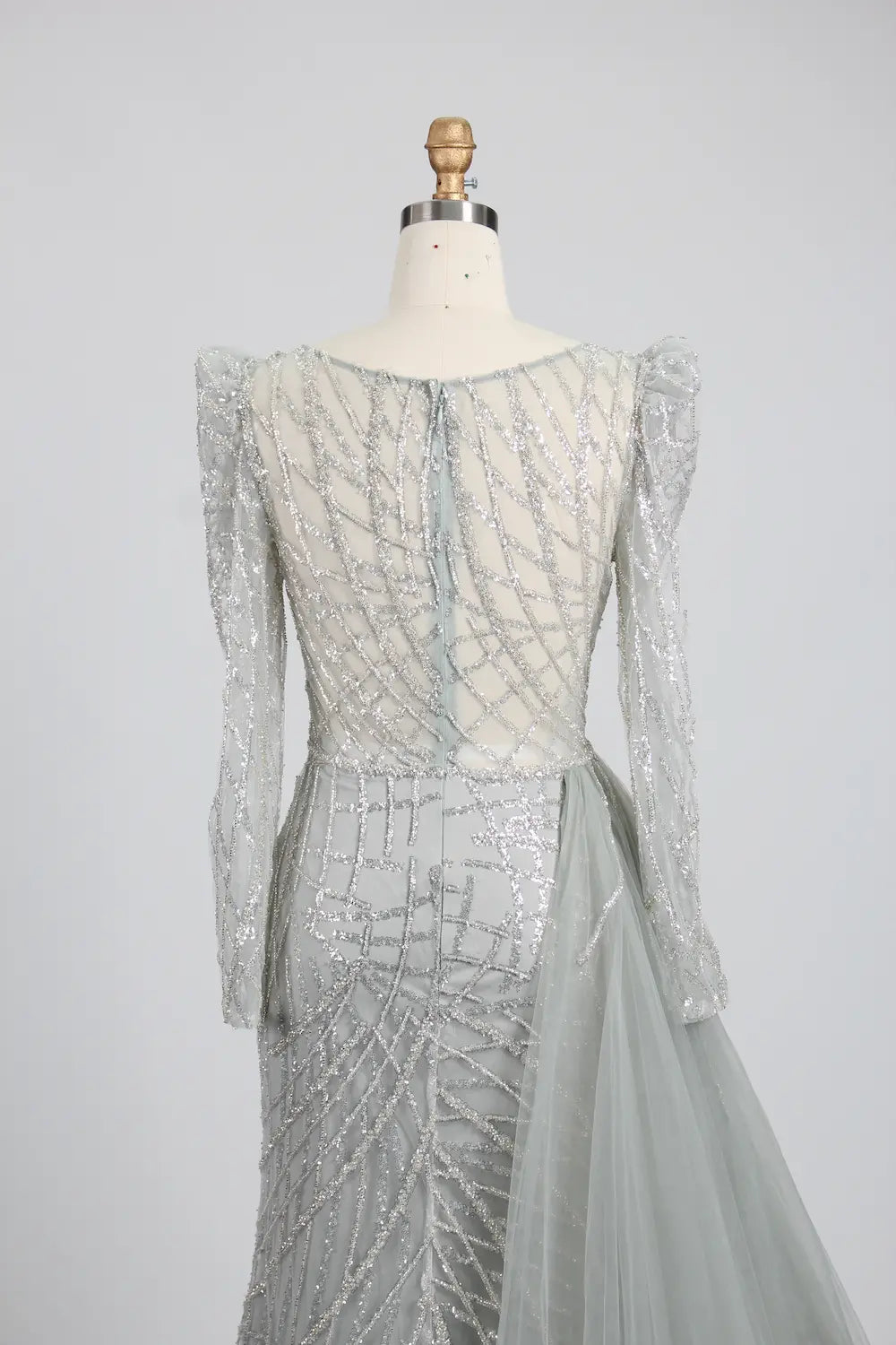 Silver long-sleeve mermaid gown with wide off-shoulder sleeves and draped back detail