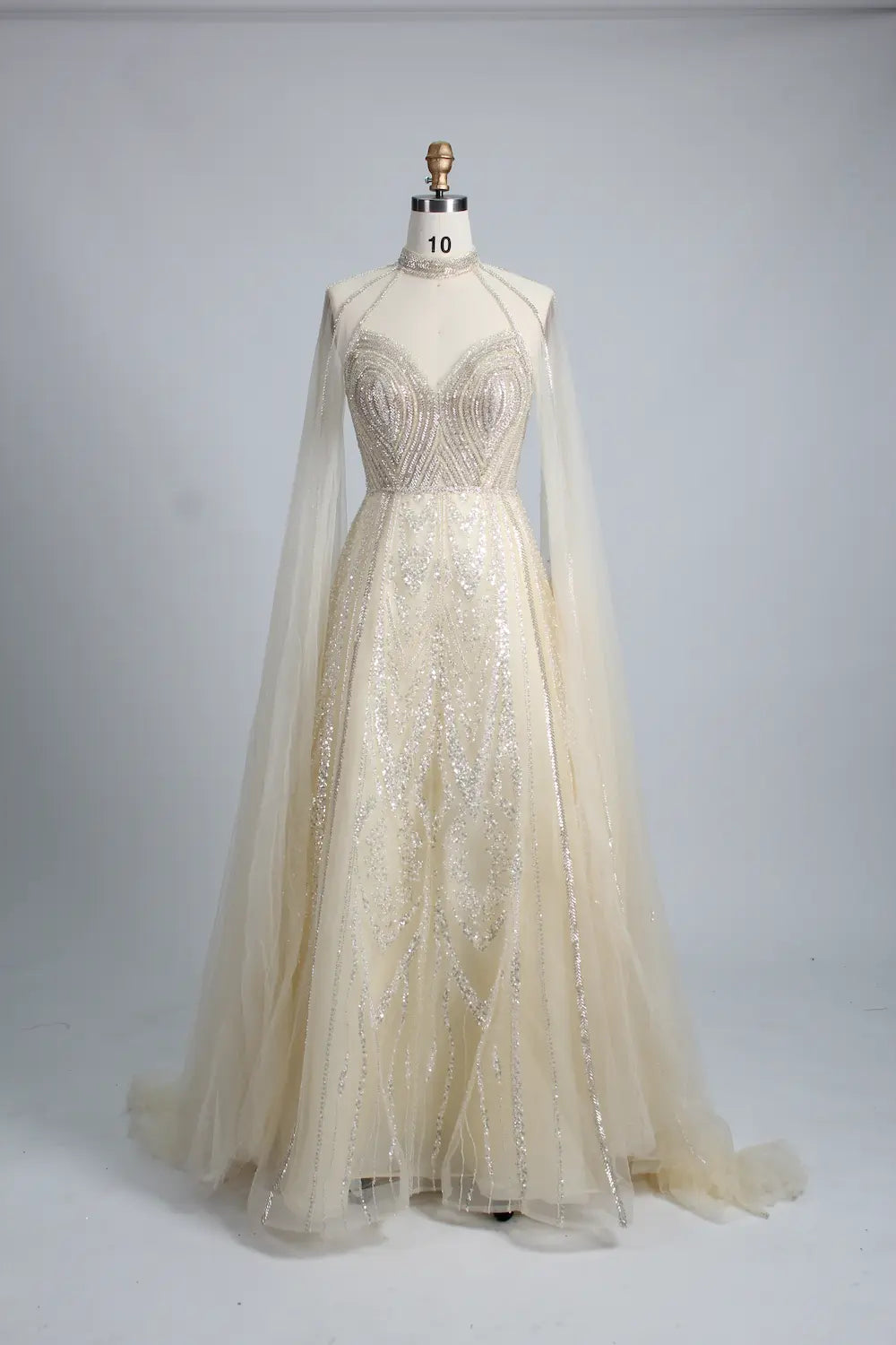 Ivory A-line cape gown with crystal beaded high-neck bodice and sheer cape