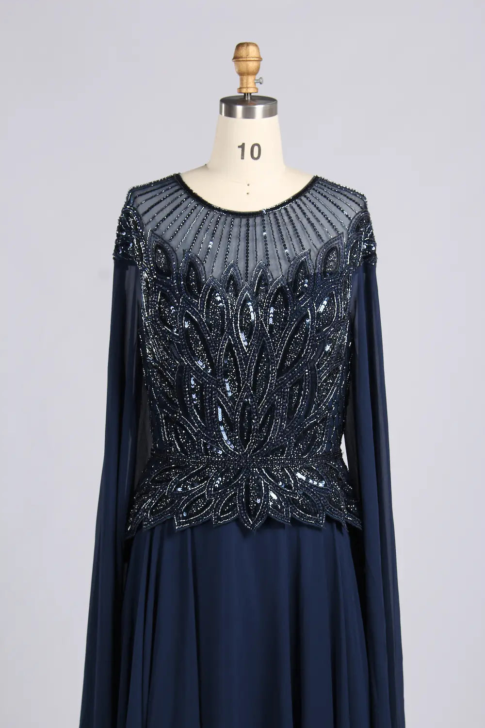 Navy A-line chiffon dress with beadwork boat neckline and long cape sleeves