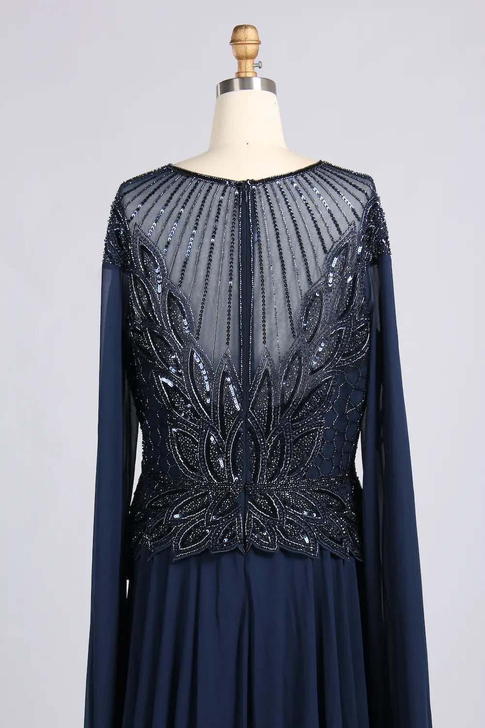 Navy A-line chiffon gown with glittering beaded back panel and long sleeves