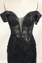 This photograph features a mannequin wearing an elegant, floor-length black lace gown. The gown has a sweetheart neckline, off-the-shoulder sleeves, and a high slit on one side, revealing a black thigh-high stocking. The intricate lace pattern is delicate and ornate, adding texture and visual interest. The mannequin stands against a plain, light beige background, emphasizing the dress's details. The number "2" is displayed on the mannequin's chest.04