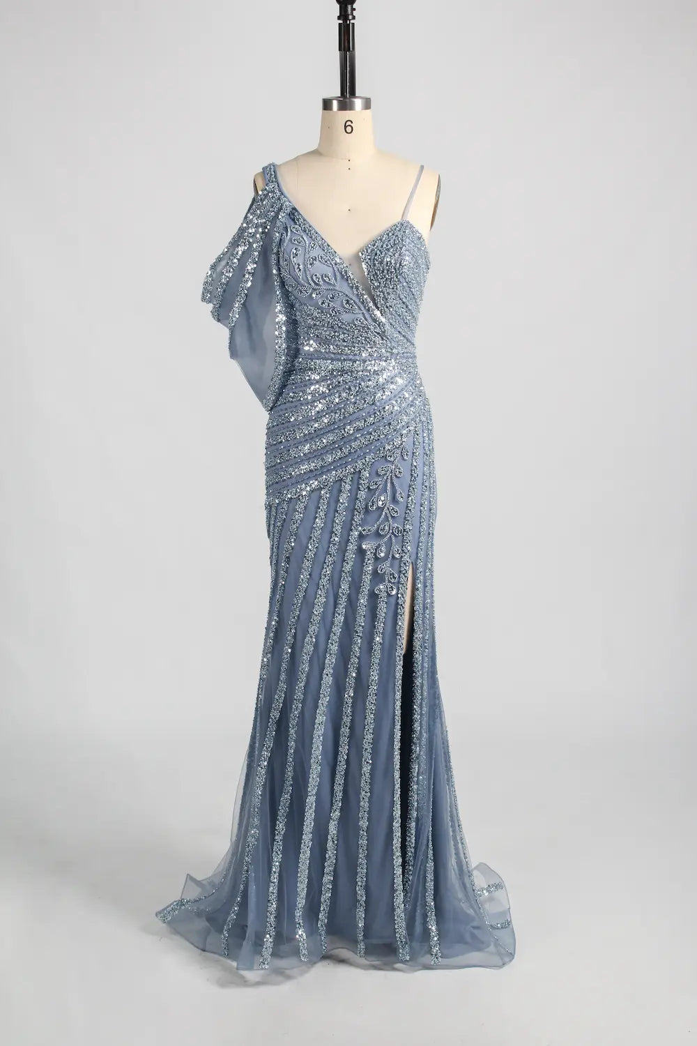 Blue one-shoulder beaded gown with fitted bodice and flowing tiered skirt