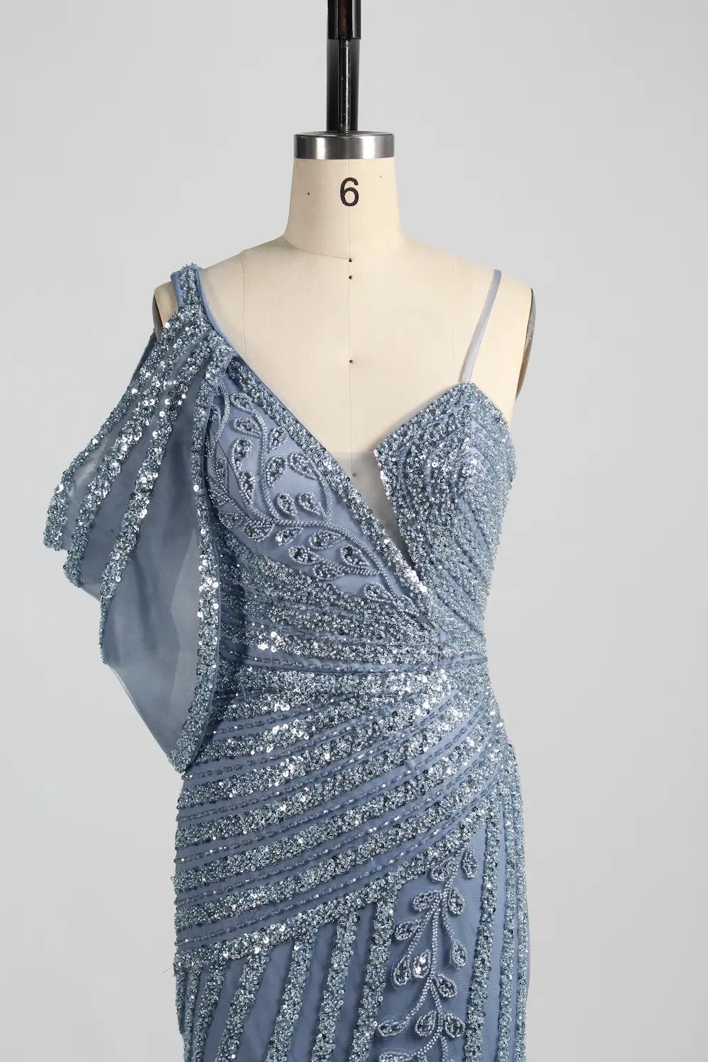 Blue asymmetric one-shoulder beaded gown with draped sleeve detail