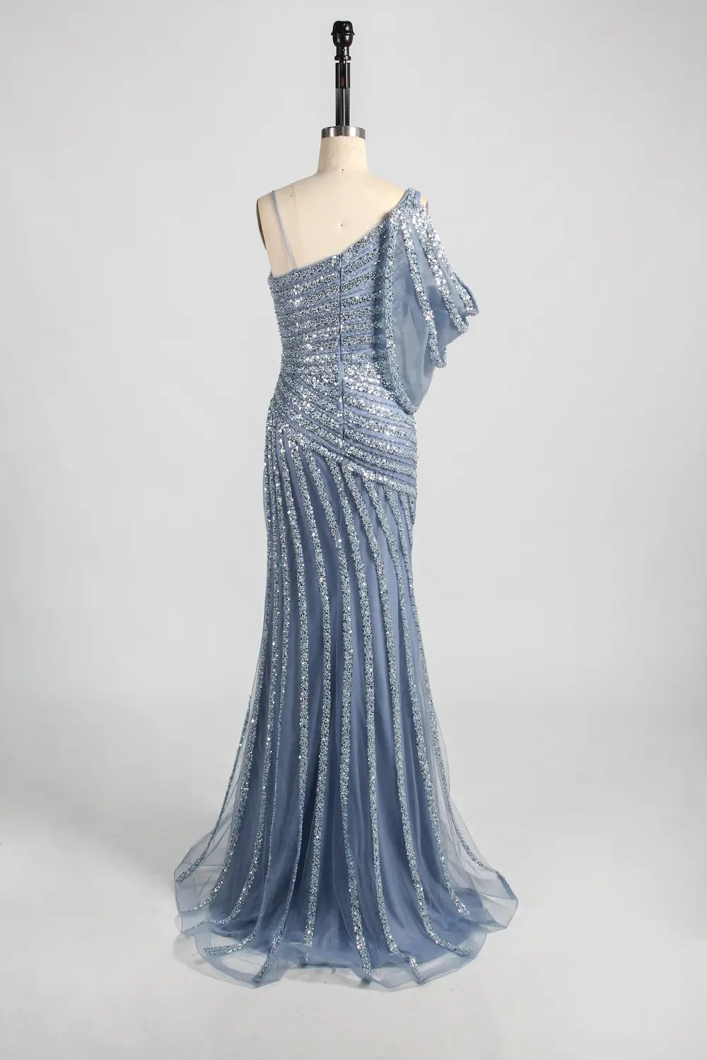 Blue one-shoulder beaded lace gown with diagonal strap and flowing skirt