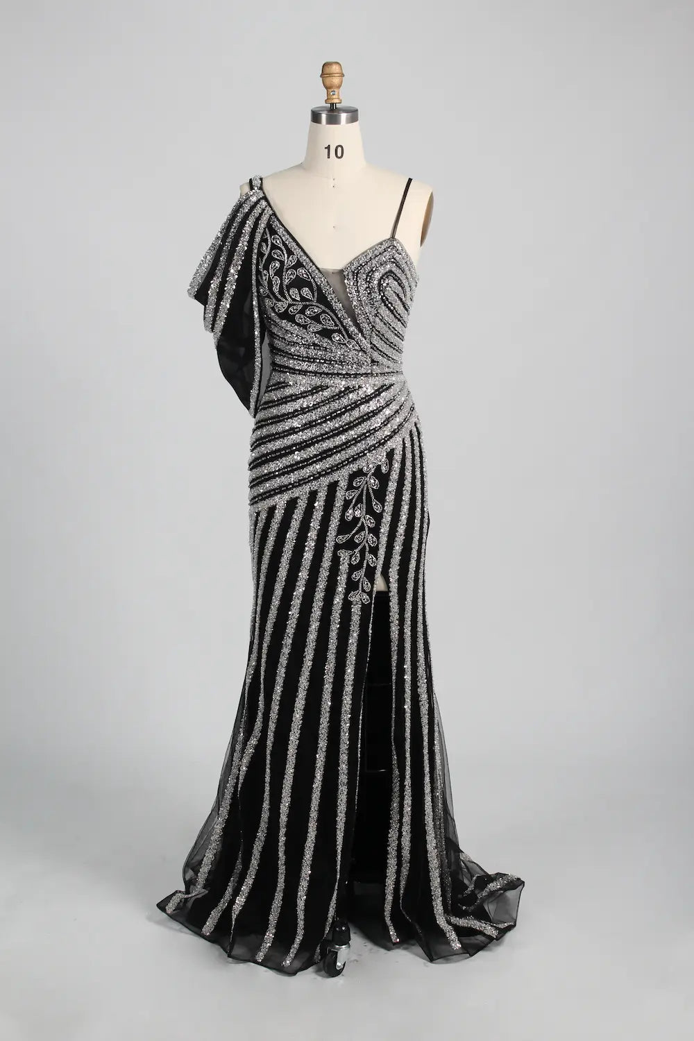 Black and silver beaded one-shoulder gown with draped shoulder and long skirt