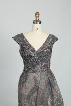 Charcoal gray sleeveless evening dress with V-neck beading and flowing A-line skirt