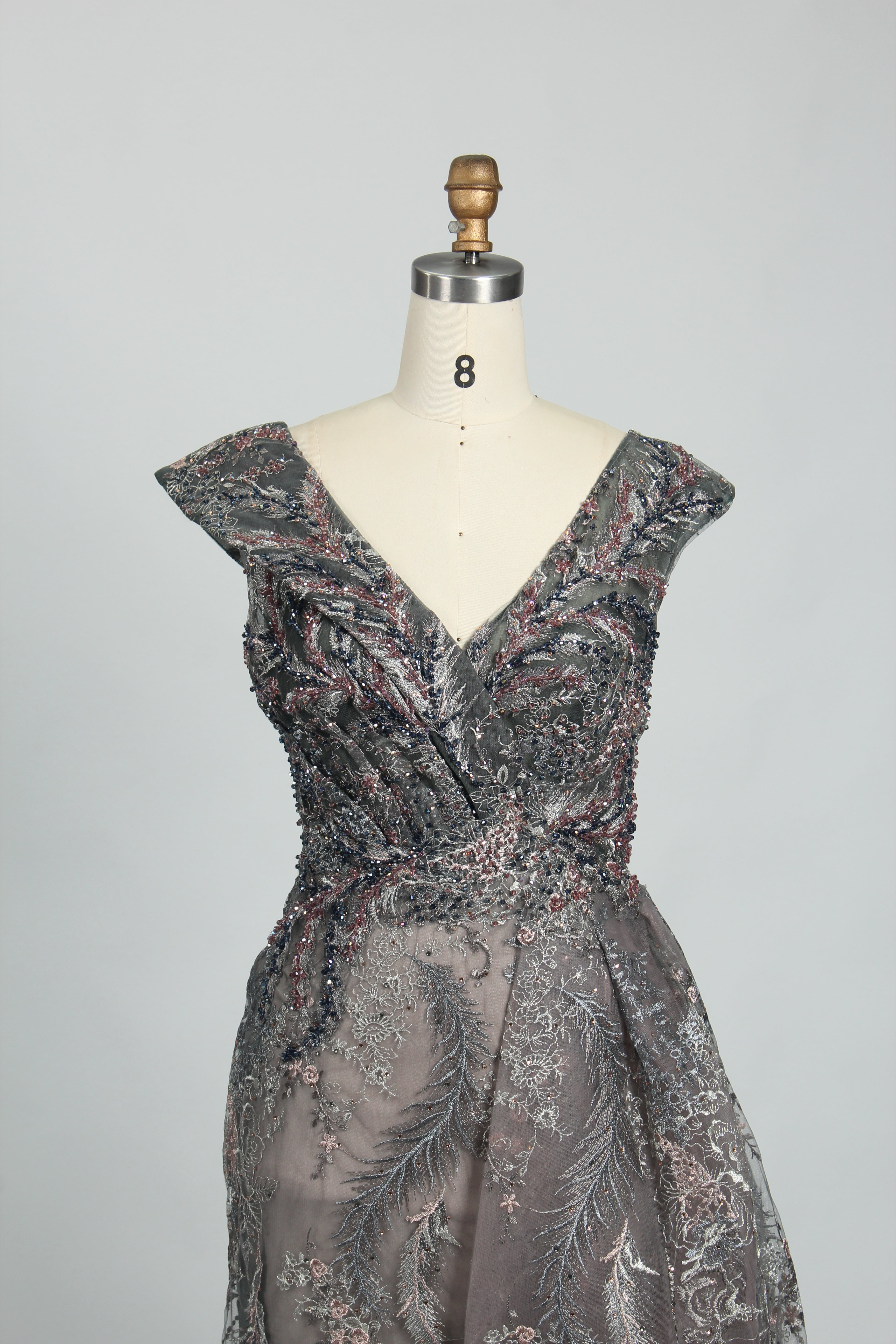 Charcoal gray sleeveless evening dress with V-neck beading and flowing A-line skirt