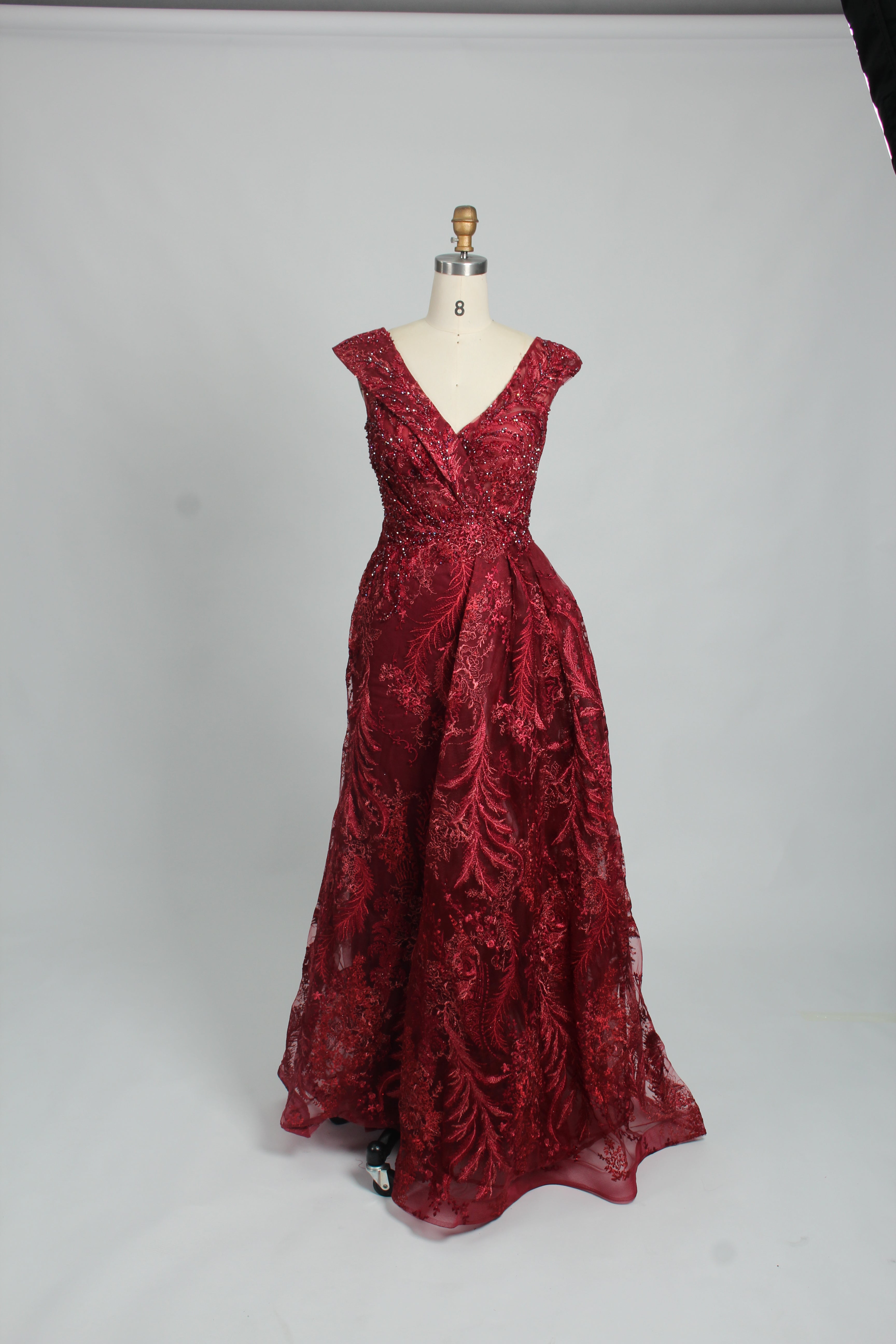 Red sleeveless evening dress with V-neck beaded details and full gathered skirt