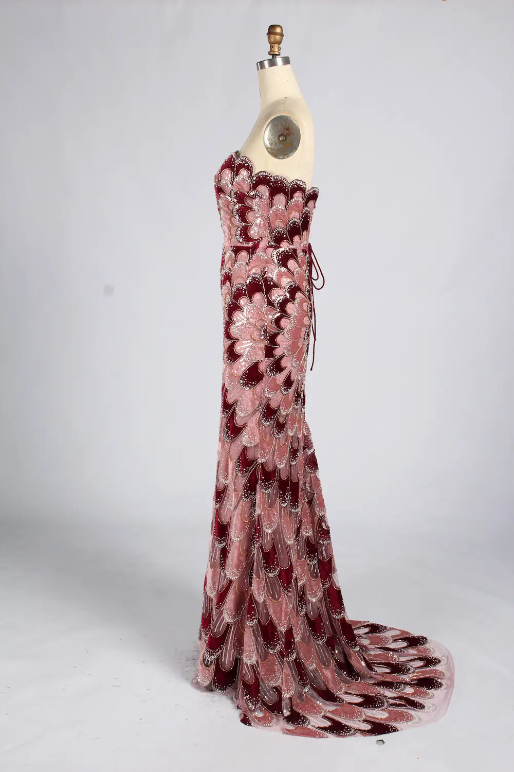 Strapless mermaid evening dress in dusty rose sequin feather pattern with long train
