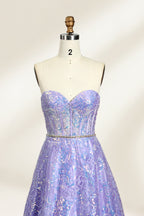 This is a purple evening gown. It has a strapless, sweetheart neckline. The bodice features intricate patterns, cinched at the waist with a thin belt. The floor - length skirt, made of tulle, is covered in iridescent embroidery. Perfect for formal events, it exudes elegance and a dreamy vibe.0
