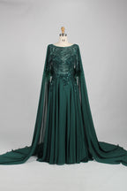 Green sequin evening dress with cape sleeves and feather-trim cuffs, flowing skirt