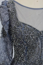Close-up of dark blue beaded crystal filigree illusion neckline and sleeves