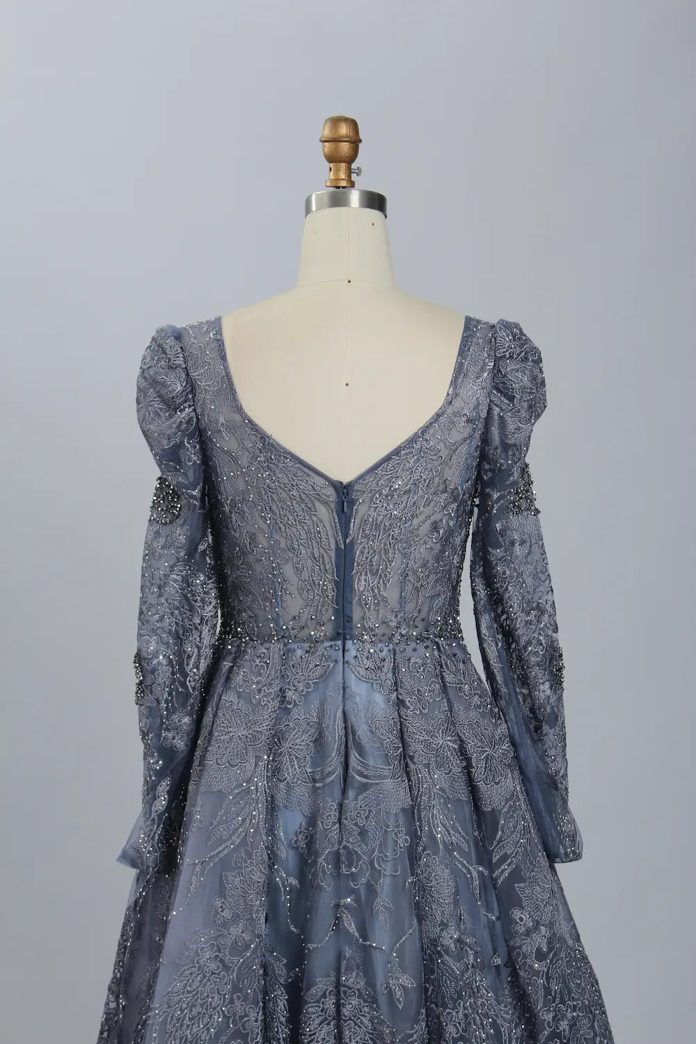 Dark blue beaded illusion V-neck dress with long puff sleeves and fitted bodice