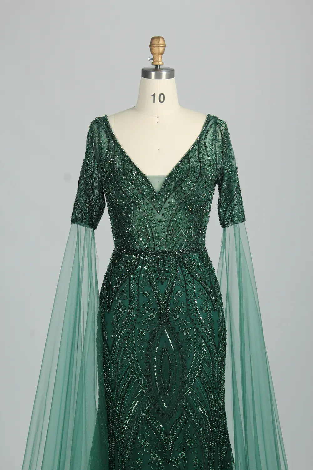 Embellished V-neck mermaid dress with short cape sleeves and dark green sequin pattern