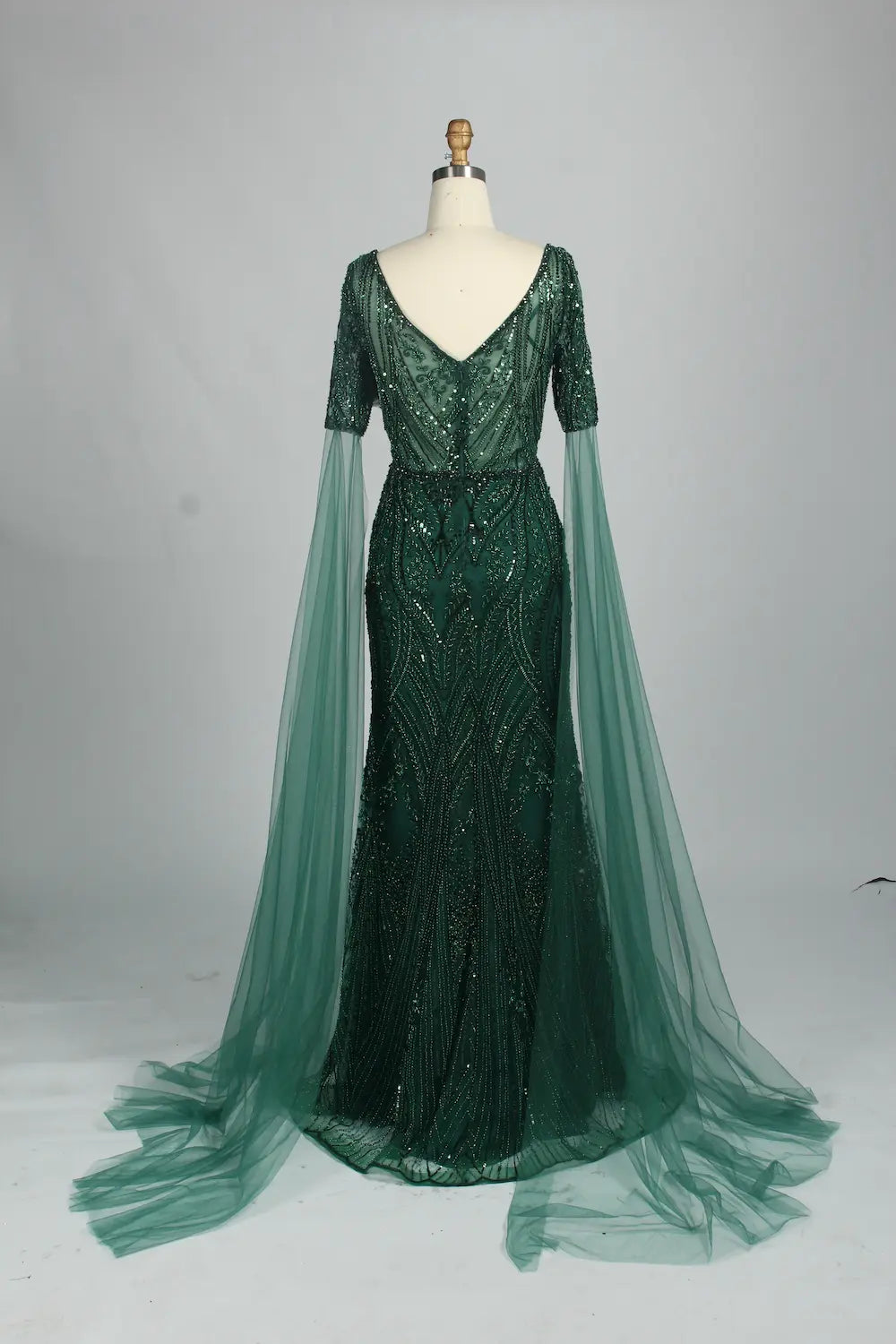 Embellished mermaid dress with V-neck, dark green sequins, and flowing tulle sleeves