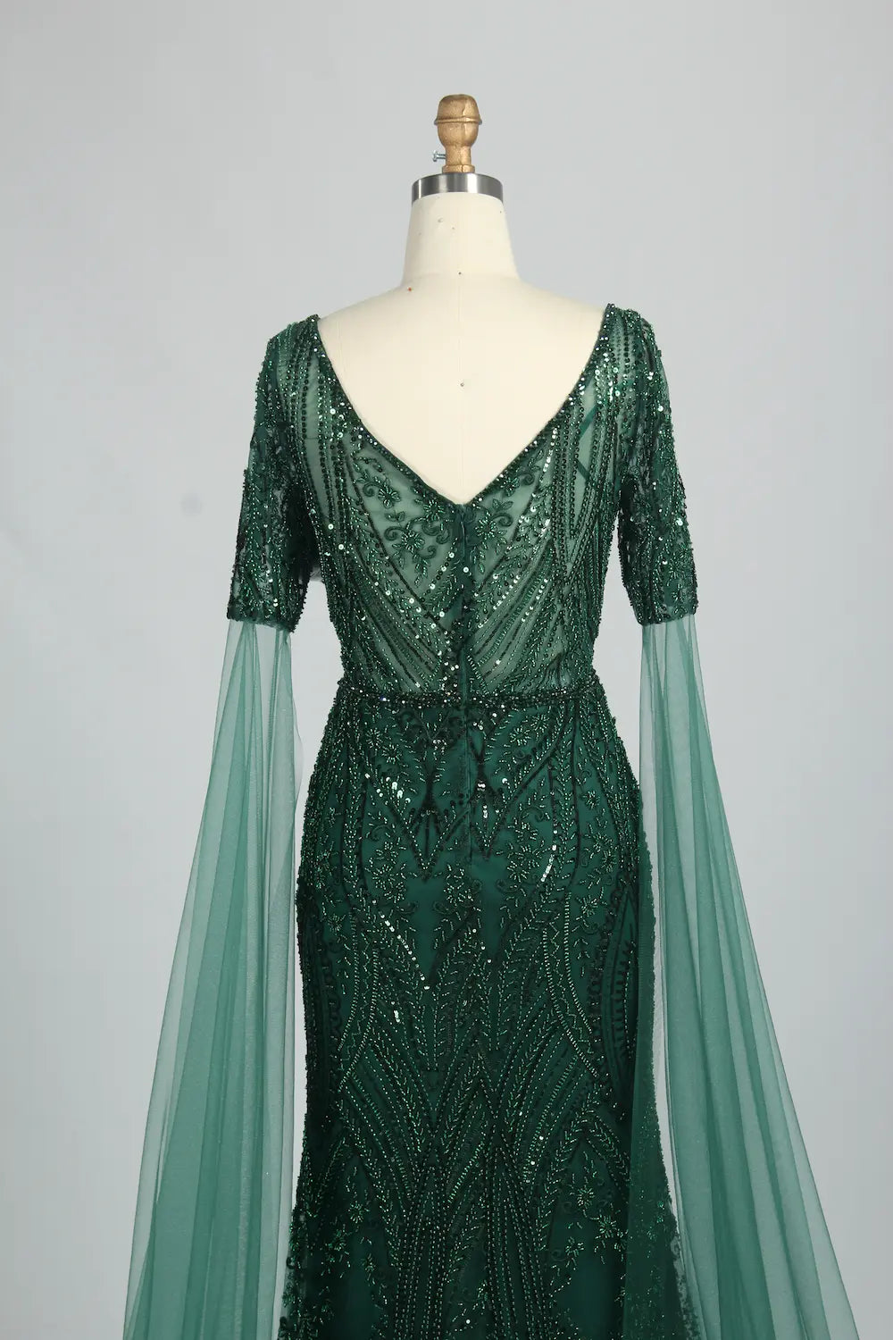 Embellished V-neck mermaid dress with dark green sequins and cape sleeves