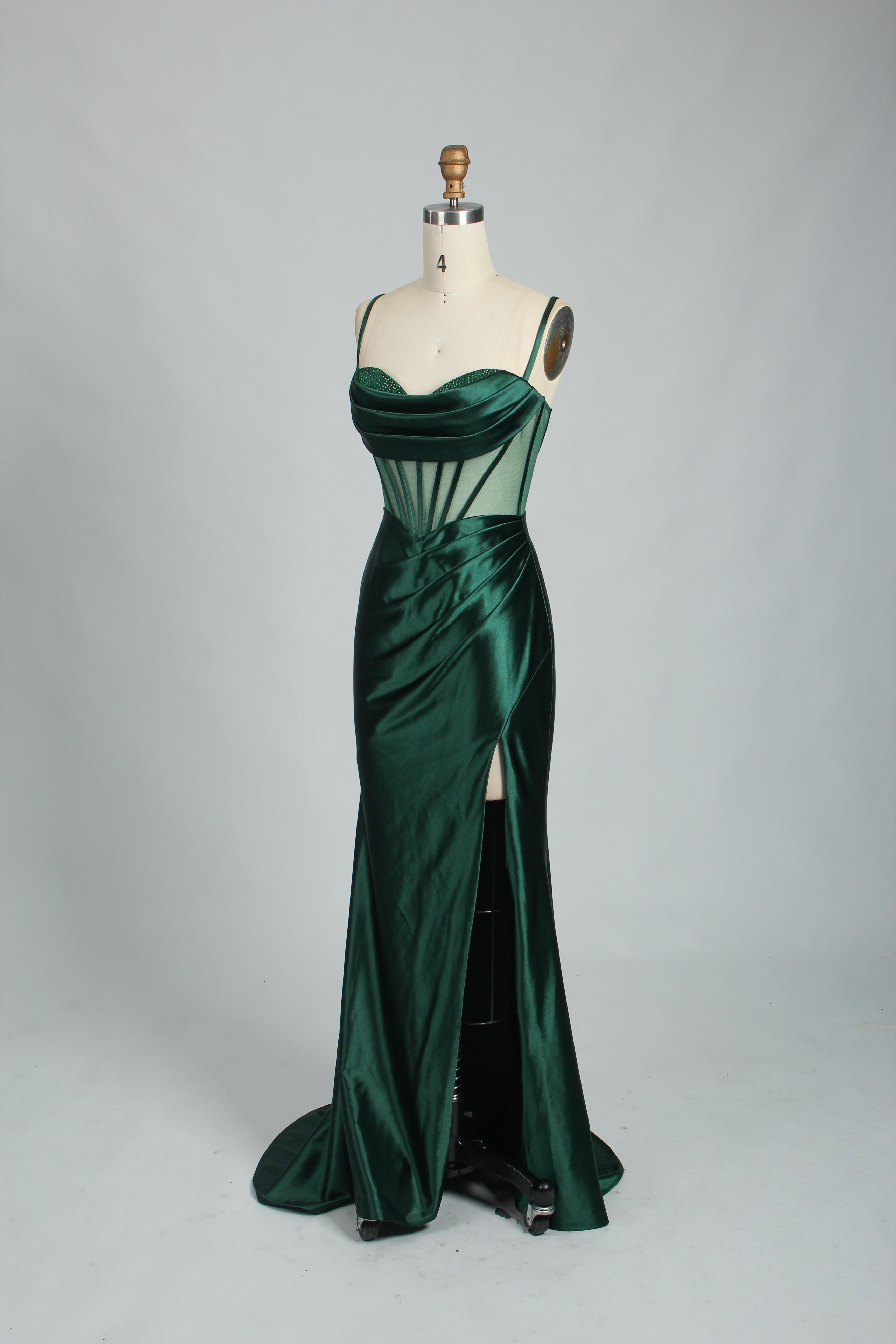 Green satin prom dress with sheer corset bodice, side slit & drape. Luxe, eye-catching design—perfect for bulk orders in premium formal collections.