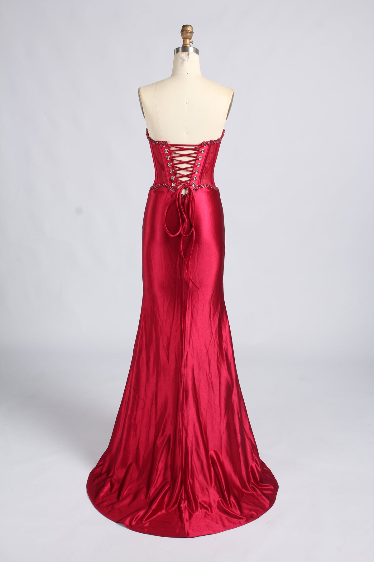 Red strapless satin mermaid prom dress with beaded corset and lace-up back