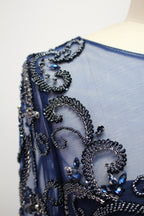 Navy blue tulle long-sleeve dress with ornate beadwork and scalloped appliques
