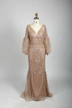 Beaded A-line cape gown in nude blush with V-neck and long puff sleeves