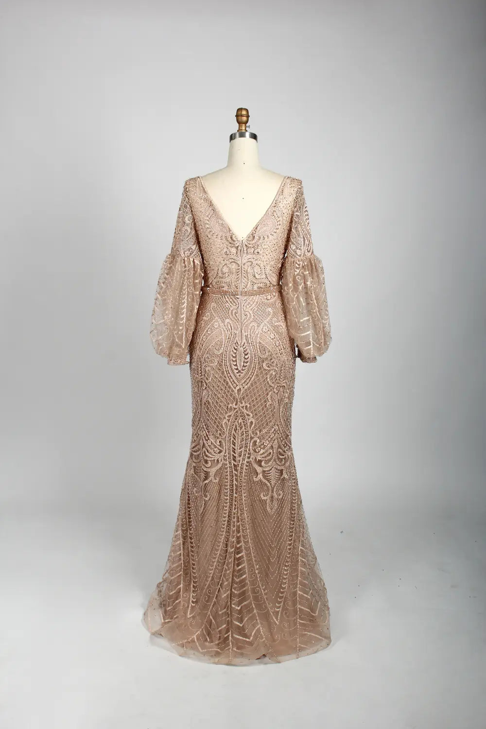 Beaded A-line cape gown in nude blush with V-neck and elbow-length puff sleeves