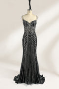 Set against a light background, a mannequin presents a black tulle gown with silver - toned beaded embellishments. Thin straps, a sweetheart neckline, and a mermaid - style skirt complete the look. The geometric bead patterns add a touch of glamour, ideal for proms or formal events where the beaded artistry stands out.1