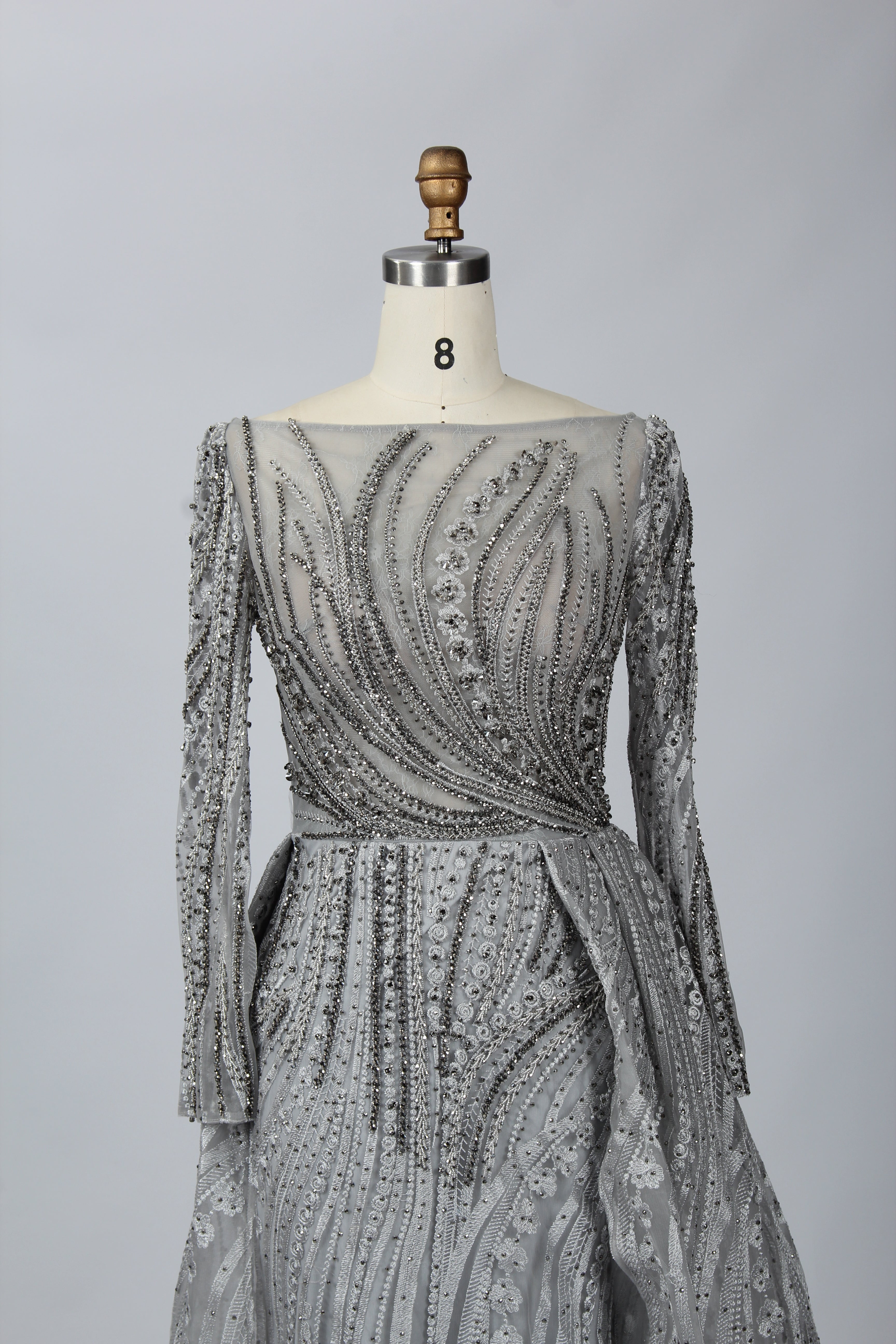 Silver-grey beaded long-sleeve evening dress with V neckline and sash belt